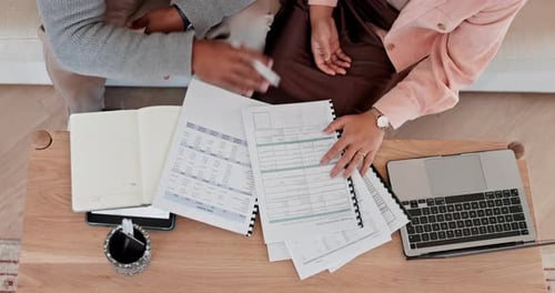 Couple Reviews Mortgage Application at Home From Above