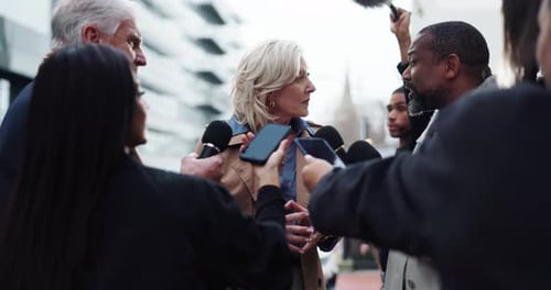 Woman Answers Questions at Outdoor Press Conference