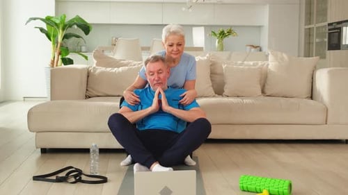 Mature Couple Exercising Together at Home