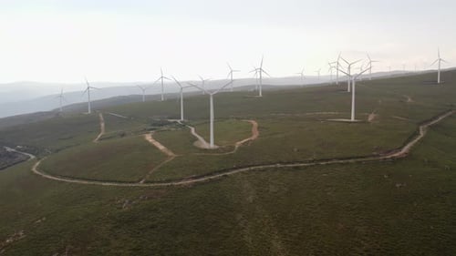 Scenic Aerial View of Wind Turbine Farm During Sunset at Mountain