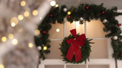 Holiday Christmas Decorations on Doorway with Festive Wreath