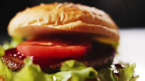 Fresh Bun Falls Down Onto Hamburger on Table Extreme Closeup