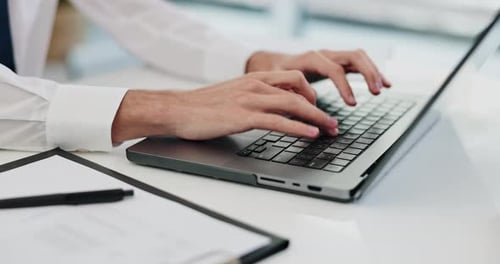 Hands Typing on Laptop Keyboard Close Up