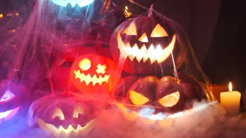 Glowing Jack-o'-Lanterns Display with Candles and Spiderwebs