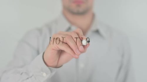 Adult Writing 'Hotvero' on Clear Surface