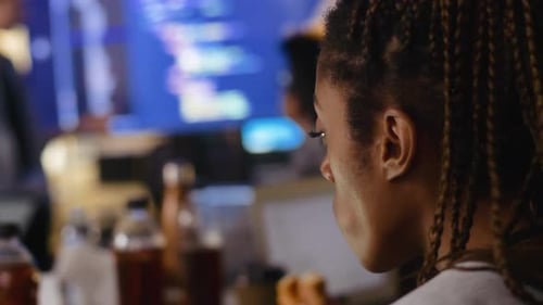 Female Hacker Eating Donut During Hackathon 2529 Years