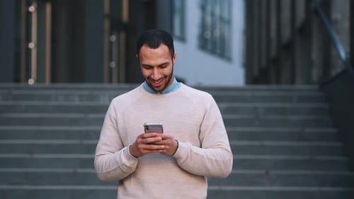 Handsome Man Using Smartphone in Urban Setting