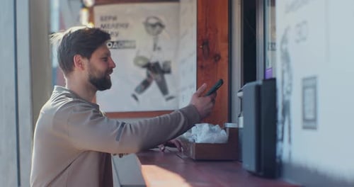 Man Pays with Phone and Receives Coffee