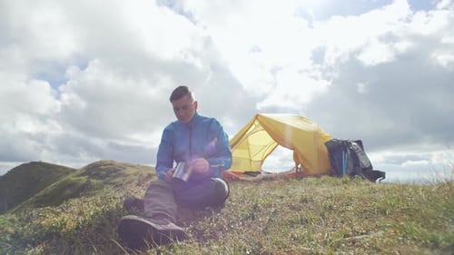 Camper Eating Meal in Rural Setting