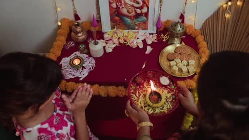 Mother and Child Praying at Diwali Altar at Home