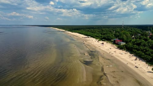 Sandy beach, small town and endless seascape, aerial drone view