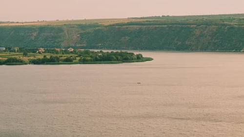 A Beautiful Scenic View Showcasing a Serene River Flowing Through a Lush Green Landscape