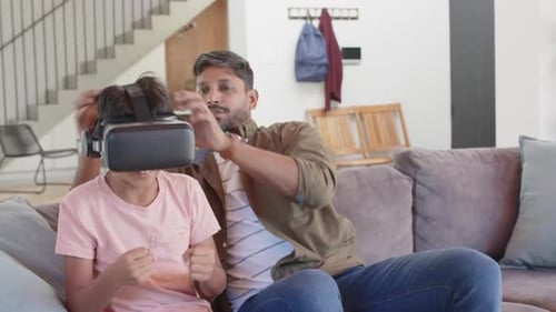Father Helps Son Use Virtual Reality Headset