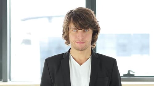 Man Looking at Camera in Office Setting