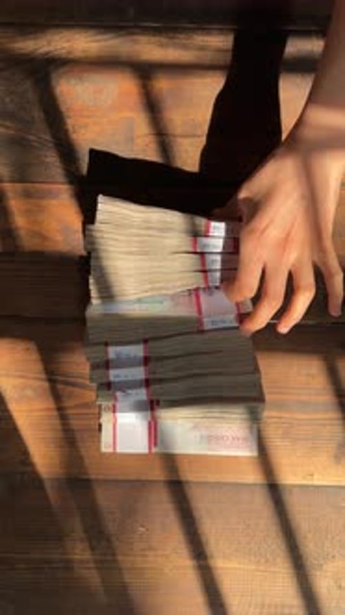 vertical video iranian banknote bundle 100 million rials versus us dollar cash wooden table backgrou