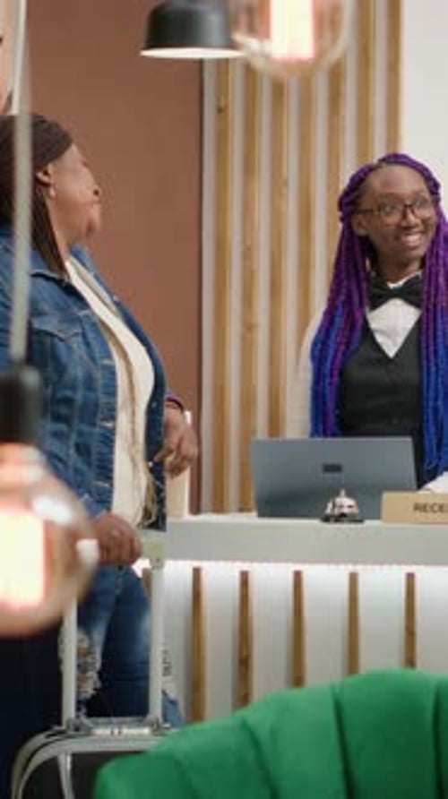 Vertical Video Receptionist Welcoming Guests at Hotel