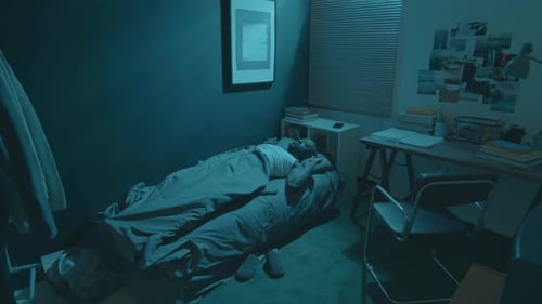 Man Wakes Up Distressed in Dark Bedroom