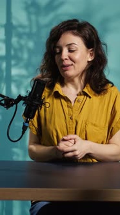 Creador de contenido de vídeo vertical que hace un relajante vídeo ASMR para fanáticos con micrófono profesional