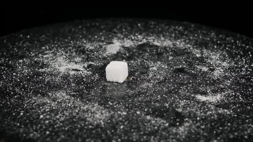 Sugar Cubes Fall on the Rotating Table in Slow Motion Close Up