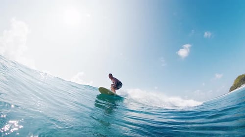 Surfer rides the wave in the ocean in the Maldives