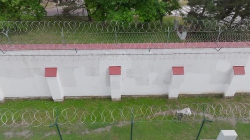 Low Orbit Around Prison Fence and Wall