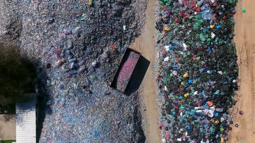 Plastic bottles and Trash Soda cans recycling piles in a local facility, Top down view