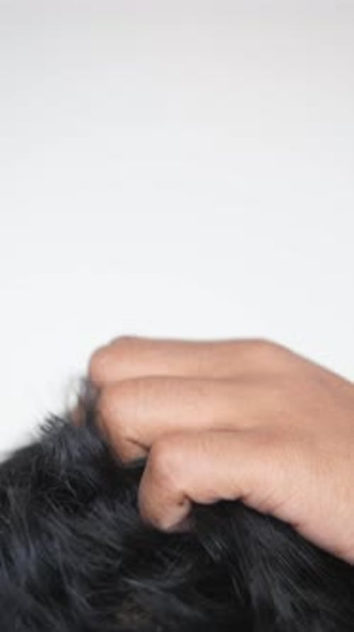 Young Man Scratching His Head