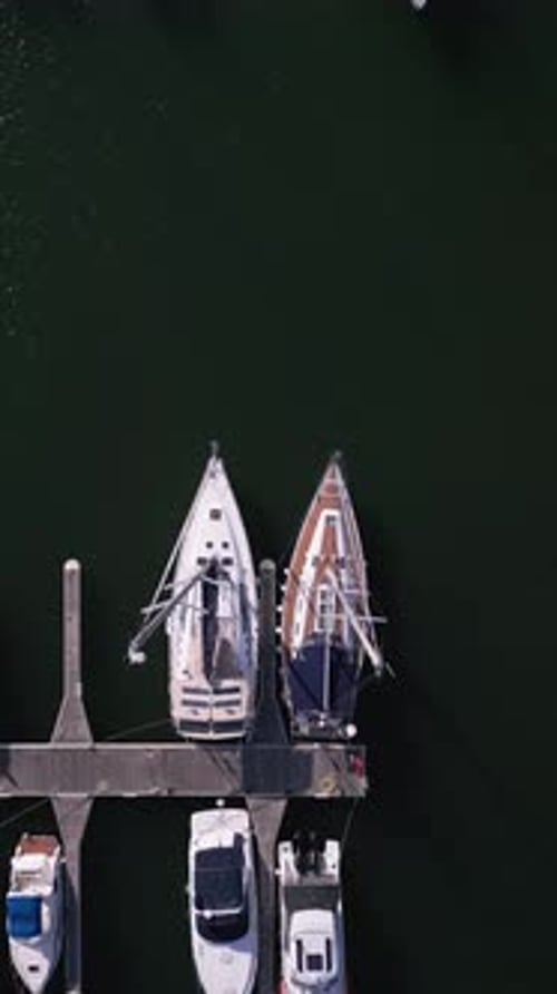 Aerial View of a Yacht Marina By the Sea Adorned with Elegant Yachts Creating a Picturesque Maritime
