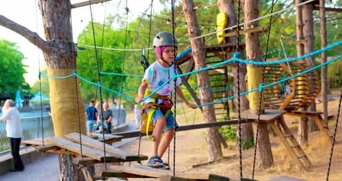 Child Navigating Ropes Course in Outdoor Adventure Park