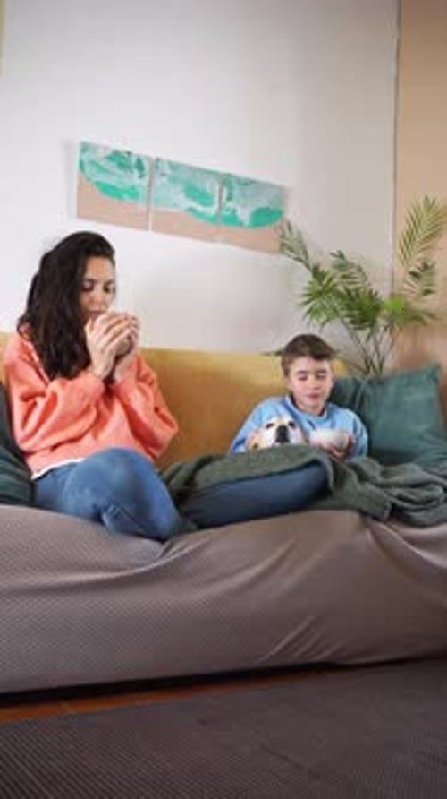 Woman and Child Relaxing on Couch at Home