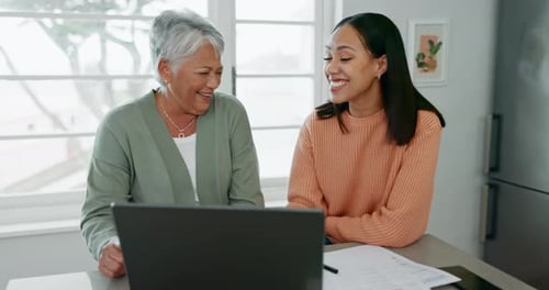 Smiling Women Use Laptop Together Indoors