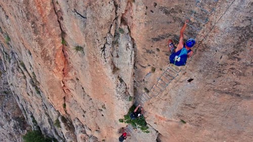 Climbers on Vertical Cliff