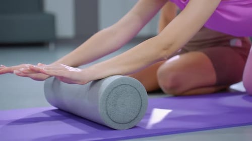 Flexibility Workout with Foam Roller and Fitness Ball in Gym
