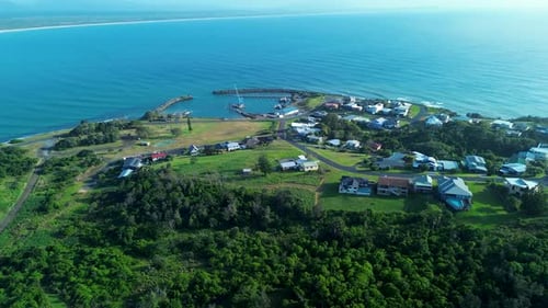 Serene Coastal Town and Marina Nestled Between Green Hills and Ocean