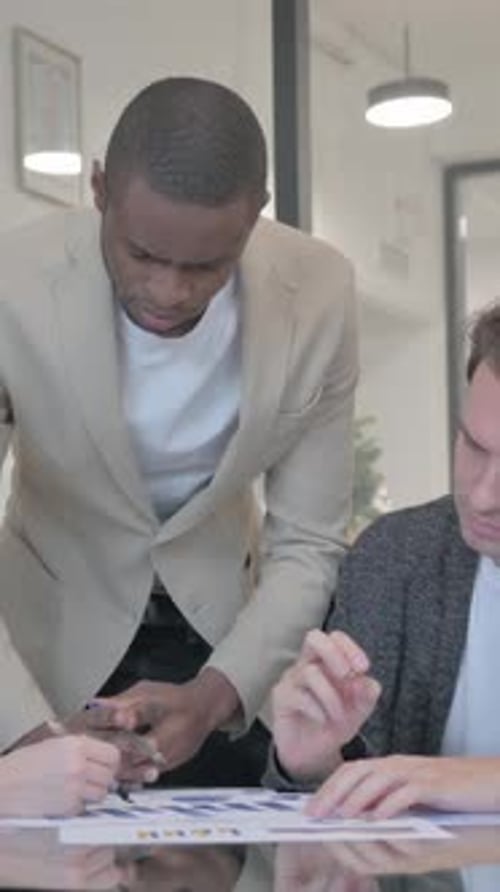 Mixed Race Entrepreneurs Discussing Work in Office, vertical video