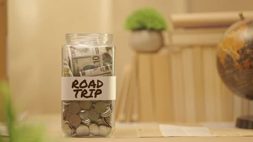 PERSON SAVING MONEY FOR ROAD TRIP