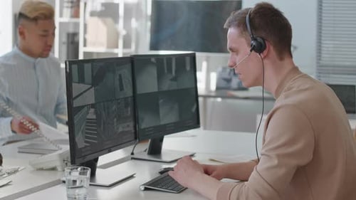 Security Team Monitoring Surveillance in Modern Office