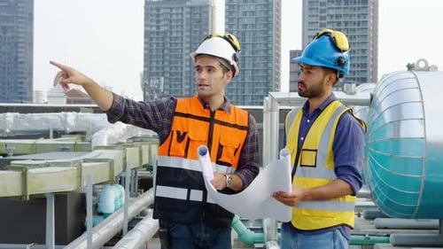Zwei Bauingenieure überprüfen die Informationen aus dem Bauplan in Teamarbeit, Projektleiter planen