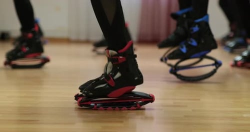 Sports girls train jumping on boots Кangoo jumps