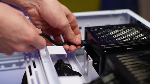 Detail Cropped Shot of Unrecognizable Man Plugging Power Cable Connector From Motherboard While