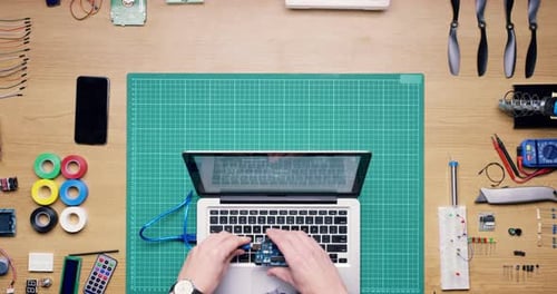 Coding, software and top view of hand with laptop fixing, repair and working with digital hardware