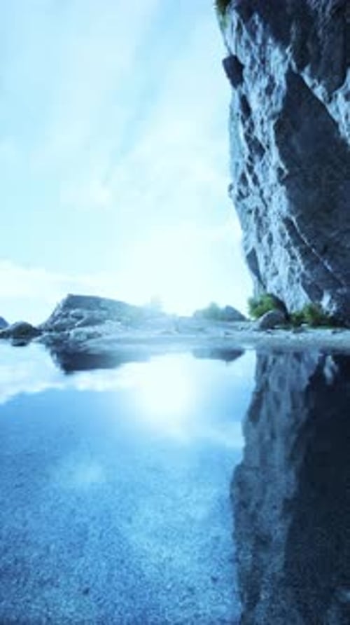 Water Body Next to Rocky Cliff