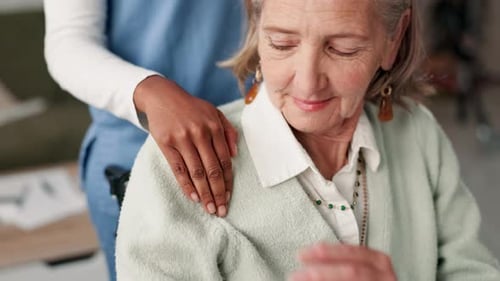Caregiver Reassuring Senior Woman Indoors