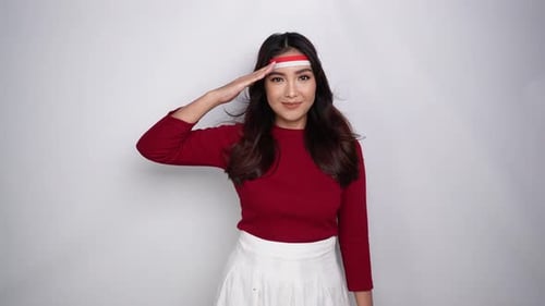 Schöne asiatische Frau, die grüßt, feiert am 17. August isoliert den indonesischen Unabhängigkeitstag