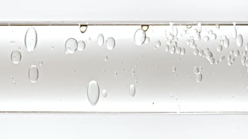 Abstract Bubbles Floating in a Clear Glass Tube