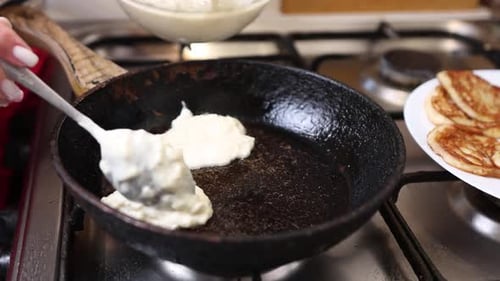 10Pancakes are fried in a pan. Cooking pancakes