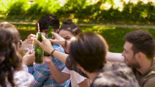 Leisure, People and Celebration Concept - Happy Friends Clinking Non Alcoholic Drinks