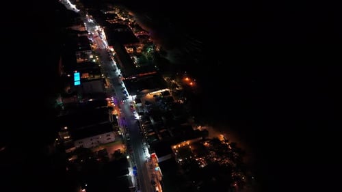 Night City Coastline Glowing with Lights and Traffic