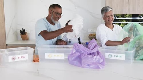 Family Sorting Recycling Together in Modern Kitchen