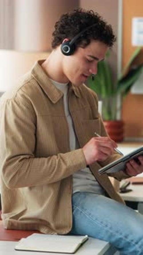 Headset, creative and man in office on tablet for seo review, media consultant and website traffic